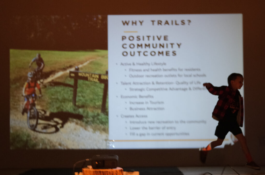 A young boy runs in front of the EAST presentation at Big Timber