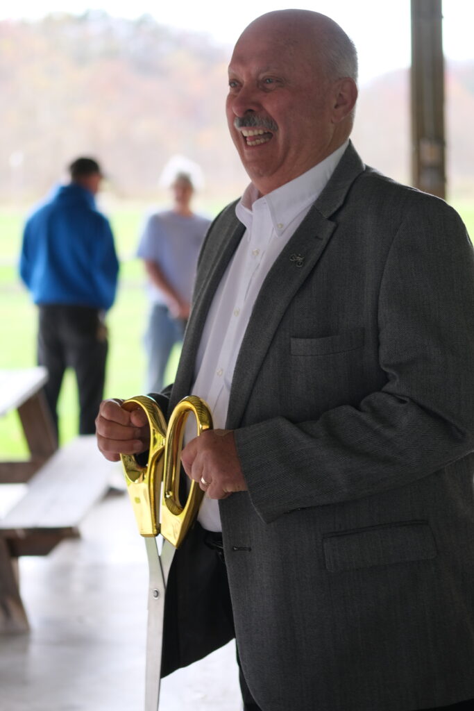Marlinton Mayor Sam Felton wields Ceremonial Scissors Following Ribbon Cutting at Monday Lick