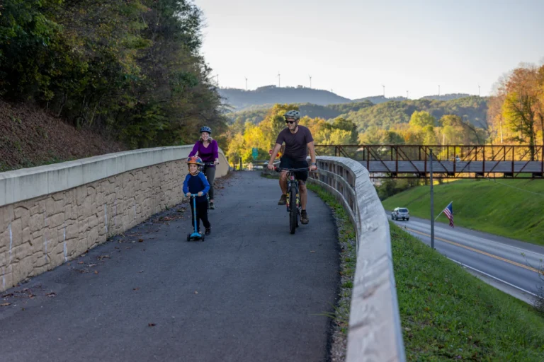 Family riding on paved Allegheny Highlands Trail in Elkins